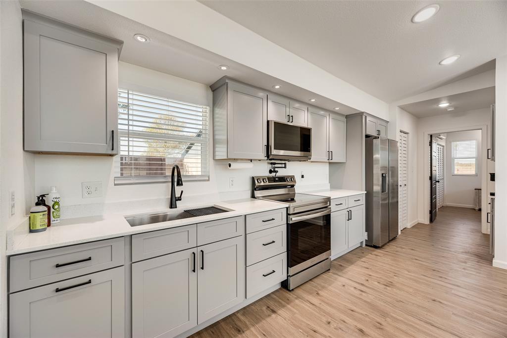 1624 Cemetery Road Royse City, TX 75189 - Photo 29 of 40 a kitchen with white cabinets and stainless steel appliances