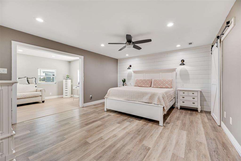 1624 Cemetery Road Royse City, TX 75189 - Photo 8 of 40 a bedroom with a large bed and a chandelier