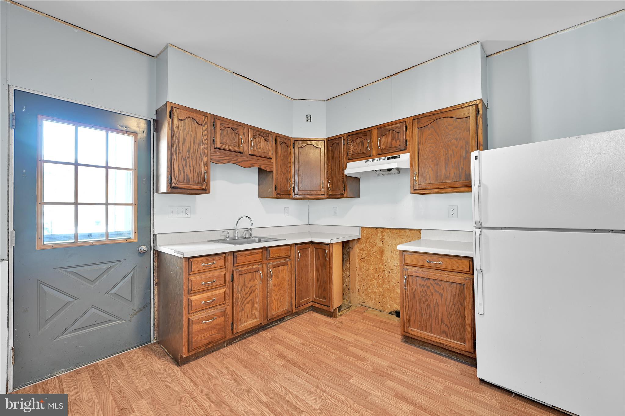 61 Mifflin Street Pine Grove, PA 17963 - Photo 12 of 31 a kitchen with stainless steel appliances granite countertop a refrigerator sink and wooden cabinets
