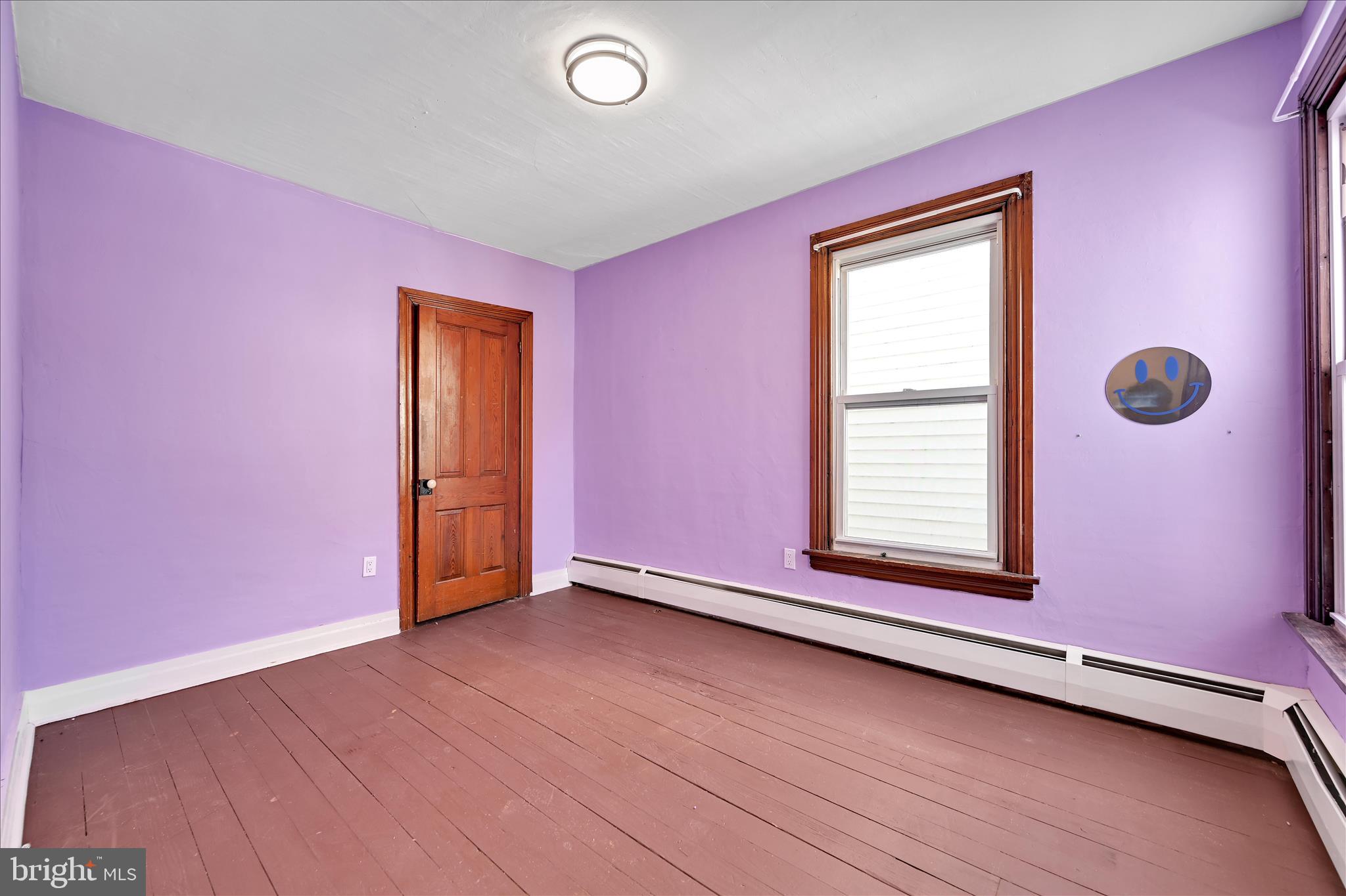 61 Mifflin Street Pine Grove, PA 17963 - Photo 18 of 31 a view of an empty room with wooden floor and a window