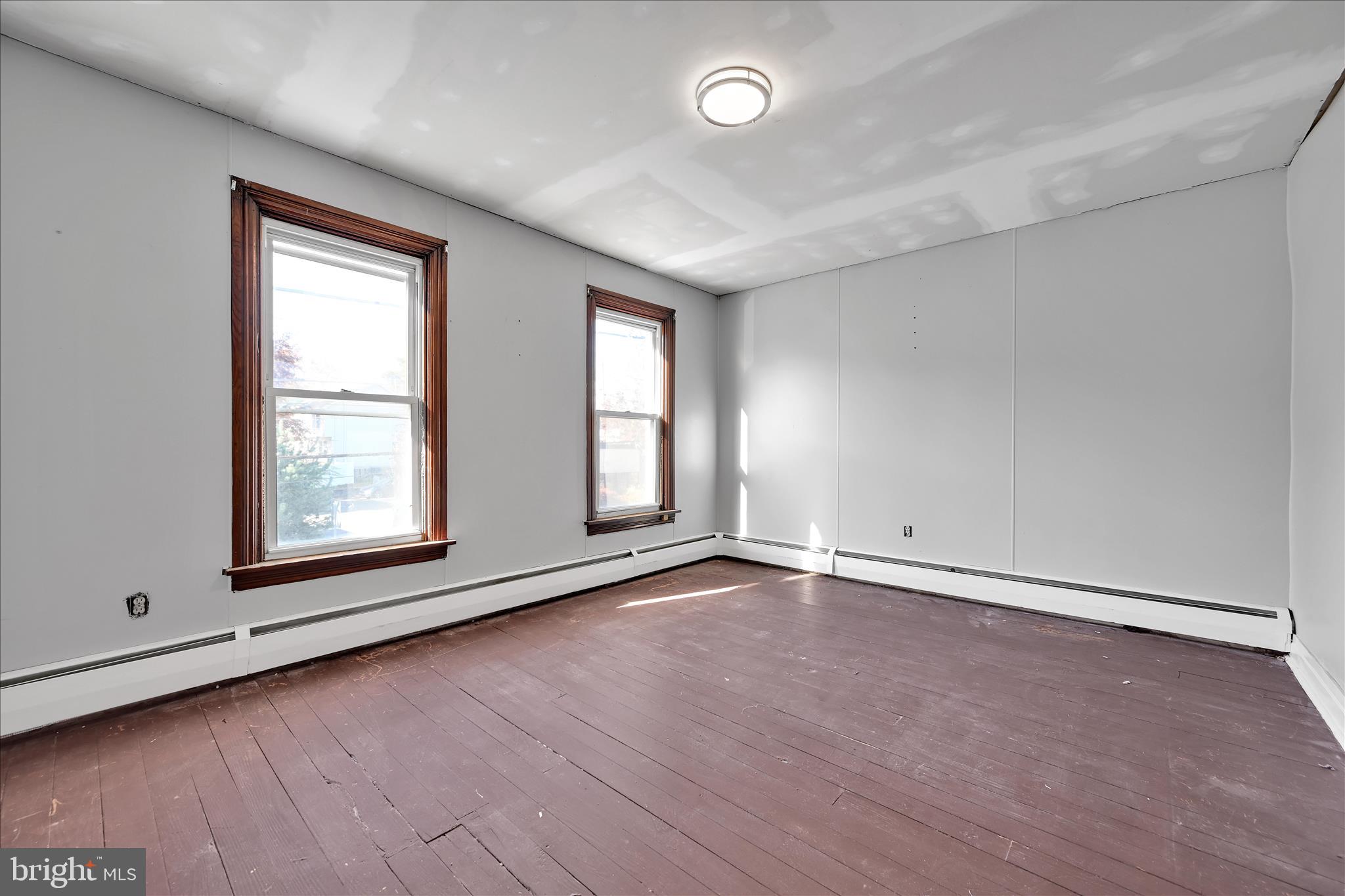 61 Mifflin Street Pine Grove, PA 17963 - Photo 21 of 31 an empty room with wooden floor and windows