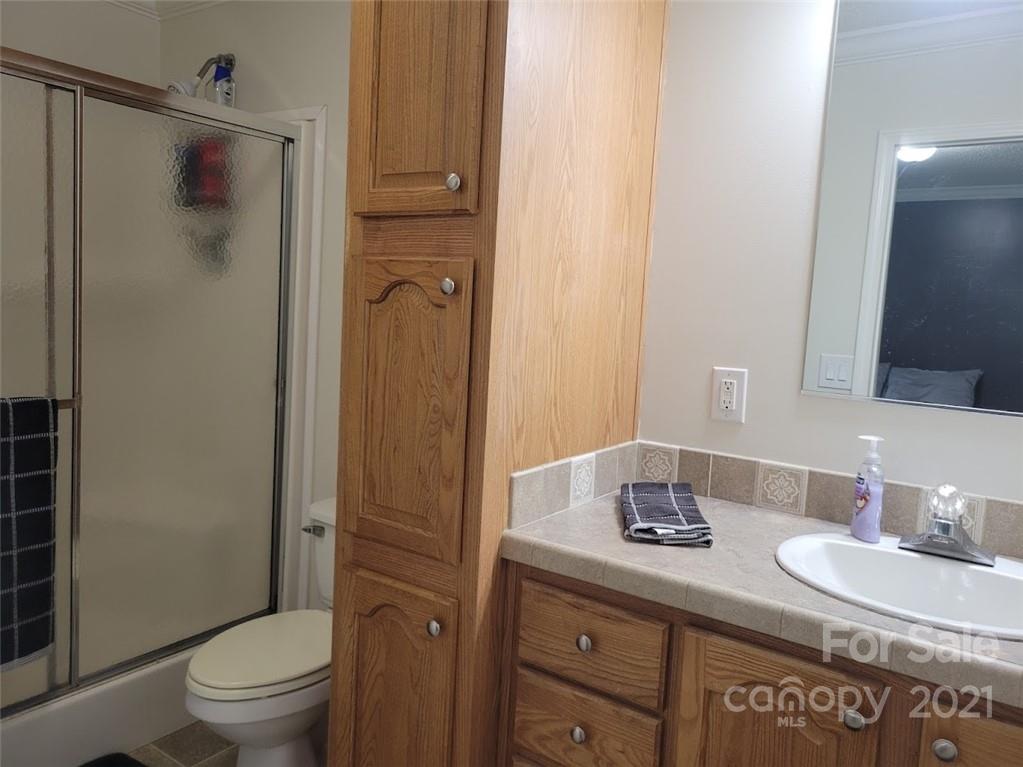 212 Hatchway Road, Unit A & B Indian Land, SC 29707 - Photo 13 of 27 a bathroom with a granite countertop sink toilet and shower