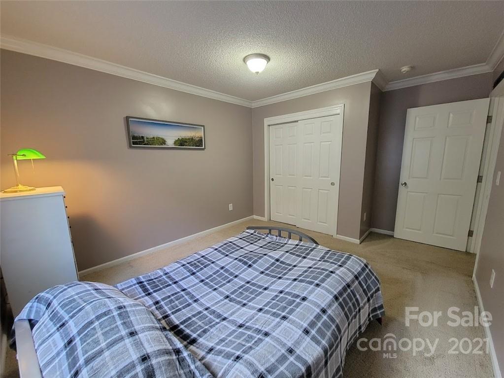 212 Hatchway Road, Unit A & B Indian Land, SC 29707 - Photo 15 of 27 a bedroom with a bed and a painting on the wall