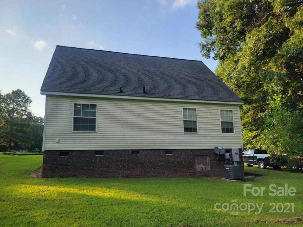 212 Hatchway Road, Unit A & B Indian Land, SC 29707 - Photo 18 of 27 a backyard of a house with potted plants and large tree