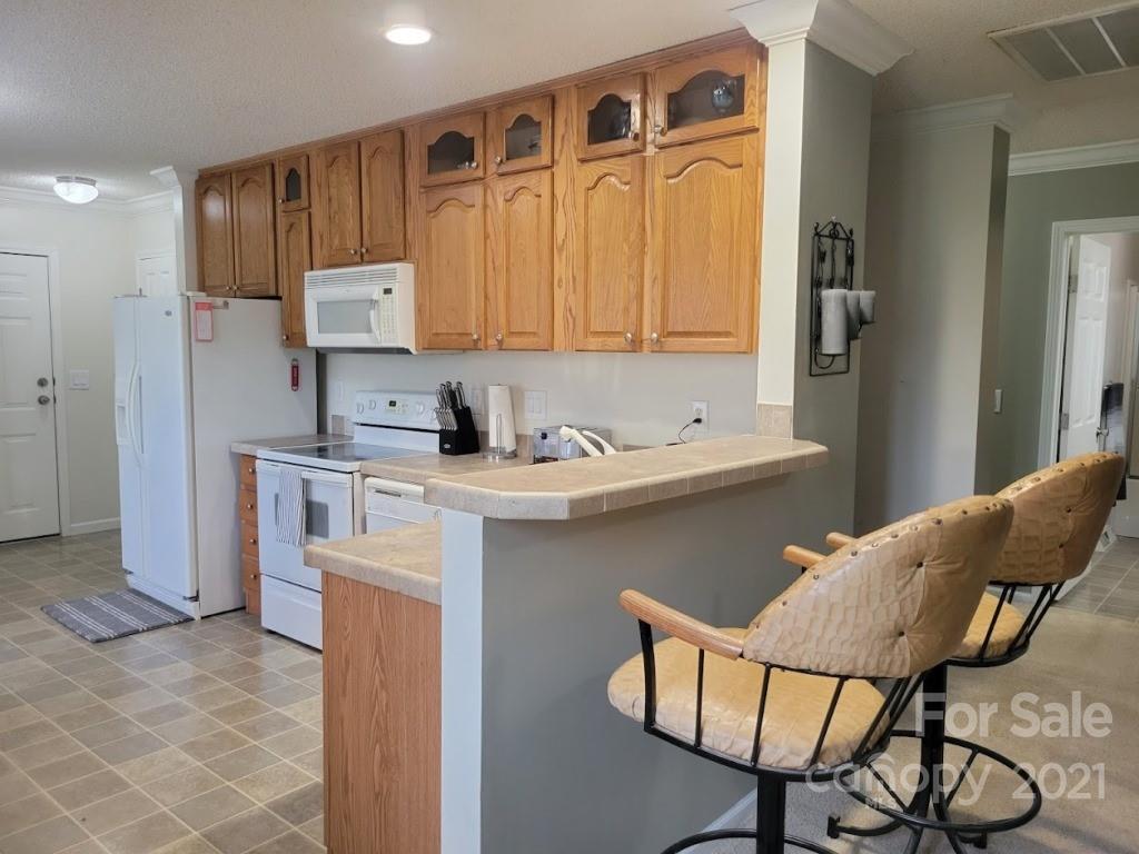 212 Hatchway Road, Unit A & B Indian Land, SC 29707 - Photo 6 of 27 a kitchen with stainless steel appliances granite countertop a refrigerator and a stove top oven