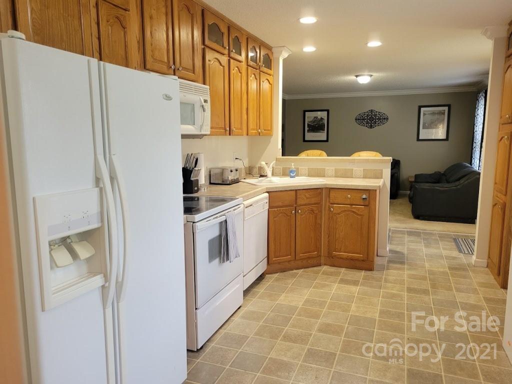 212 Hatchway Road, Unit A & B Indian Land, SC 29707 - Photo 9 of 27 a kitchen with a sink a refrigerator a washer dryer and cabinets