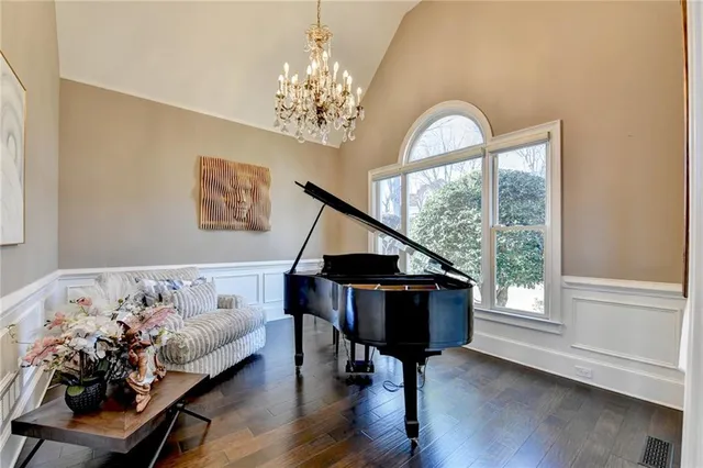 a living room with furniture a fireplace and a chandelier