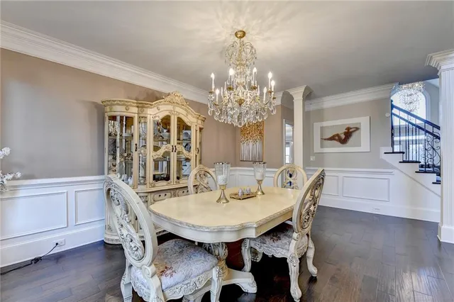 an open kitchen with granite countertop a stove and a wooden floor