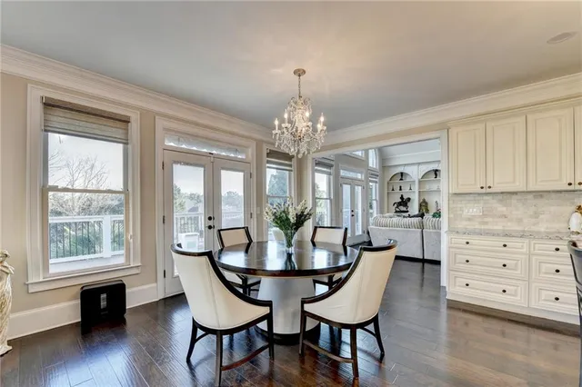 a view of a livingroom with wooden floor and a ceiling fan