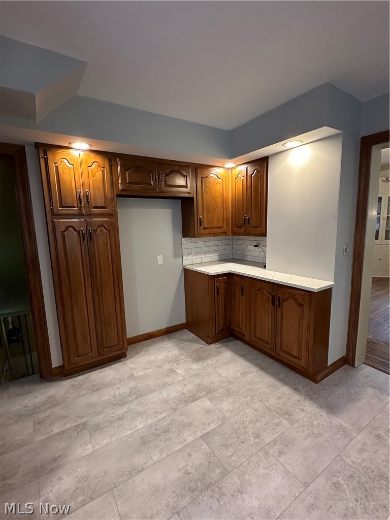 910 Cambridge Road Coshocton, OH 43812 - Photo 12 of 30 Kitchen with backsplash and light tile floors