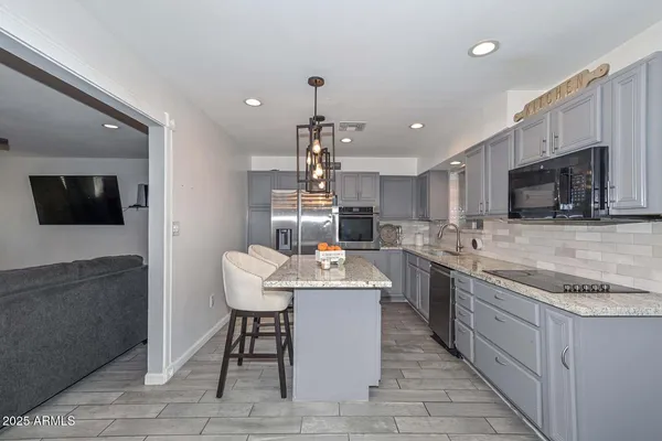 a kitchen with counter top space cabinets and appliances