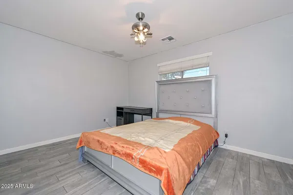 a bedroom with a bed and a chandelier