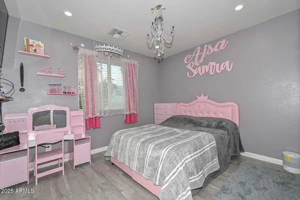 a bedroom with a bed and a chandelier