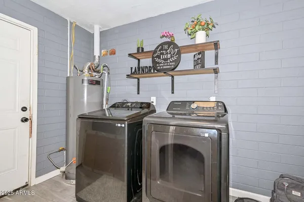 a view of a storage and utility room with washer and dryer