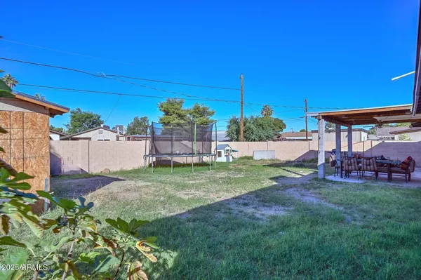 a view of a backyard with plants and a patio