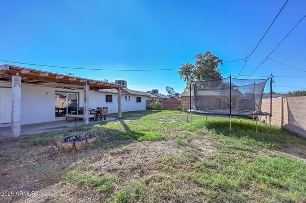 a view of house with backyard