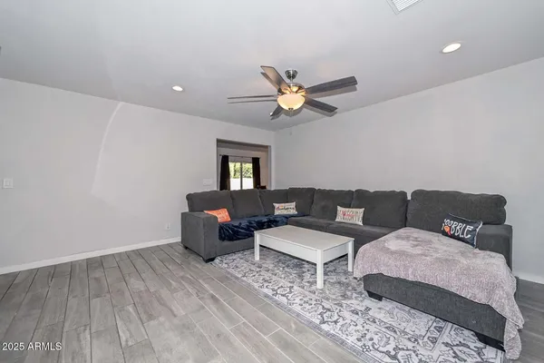 a bedroom with furniture and a wooden floor