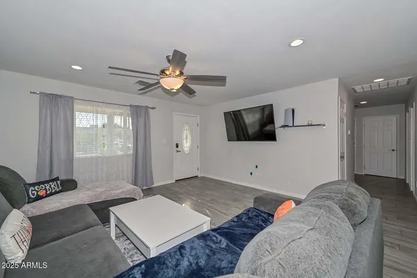 a living room with furniture and a flat screen tv