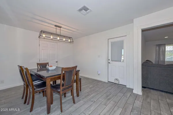 a view of a dining room with furniture and wooden floor
