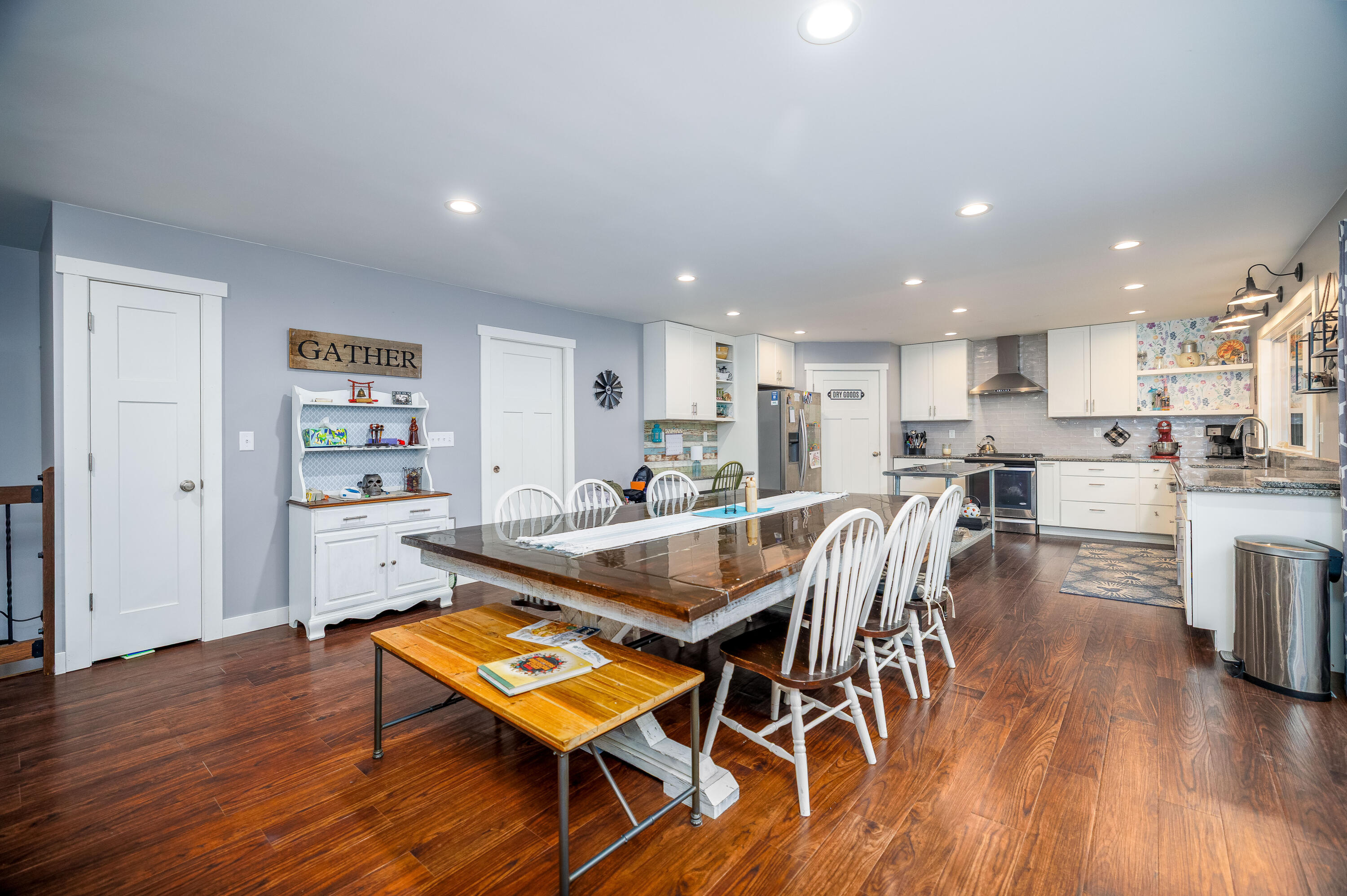 6795 Whispering Woods Drive Demotte, IN 46310 - Photo 20 of 64 a dining room with stainless steel appliances wooden floor dining table and chairs