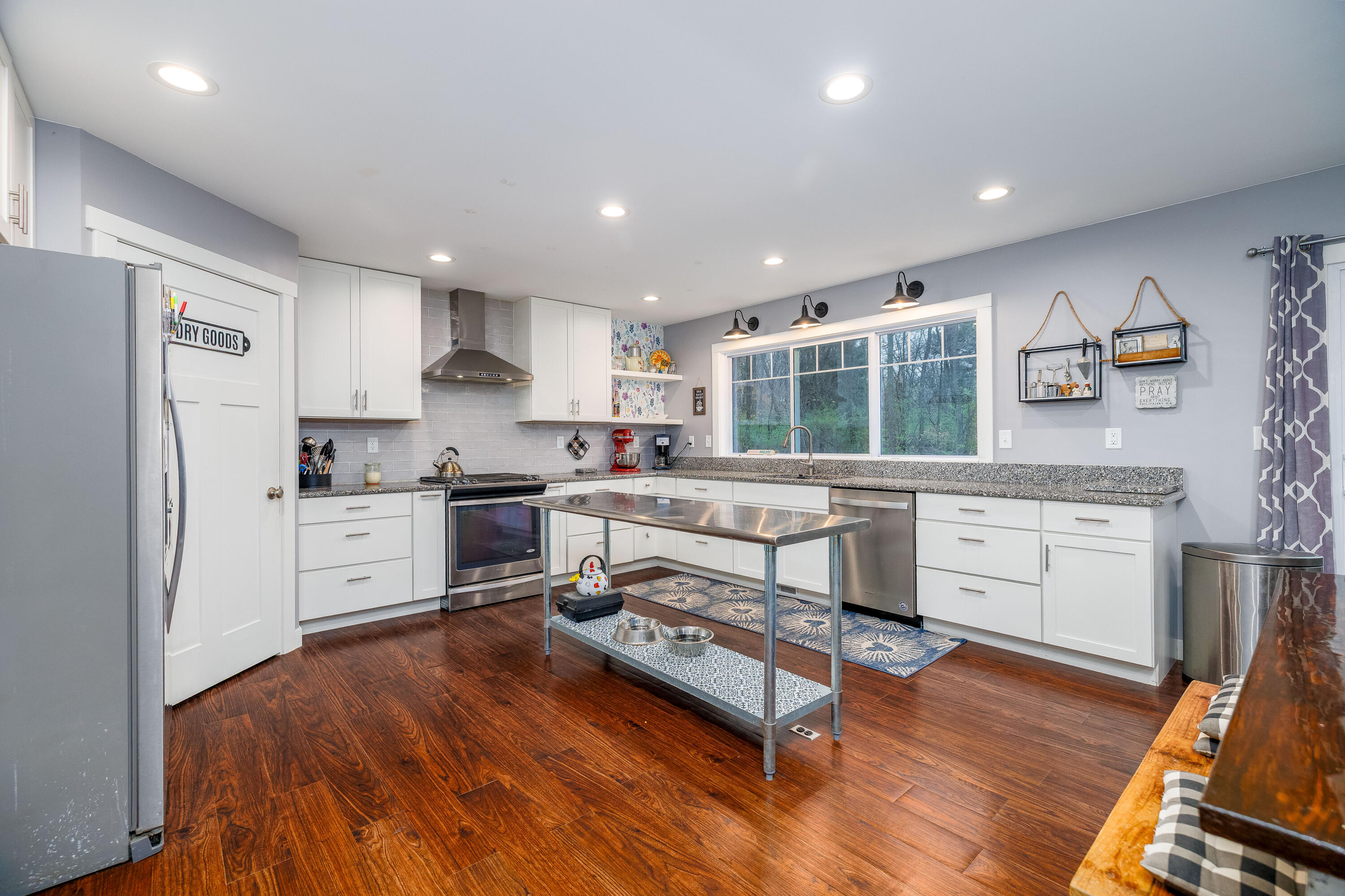 6795 Whispering Woods Drive Demotte, IN 46310 - Photo 24 of 64 a kitchen with white cabinets and stainless steel appliances