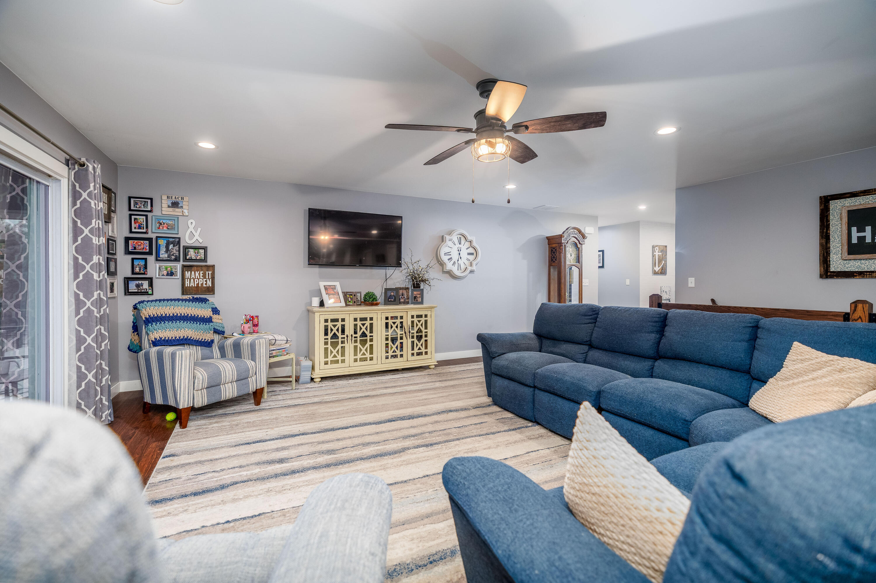 6795 Whispering Woods Drive Demotte, IN 46310 - Photo 29 of 64 a living room with furniture and a flat screen tv