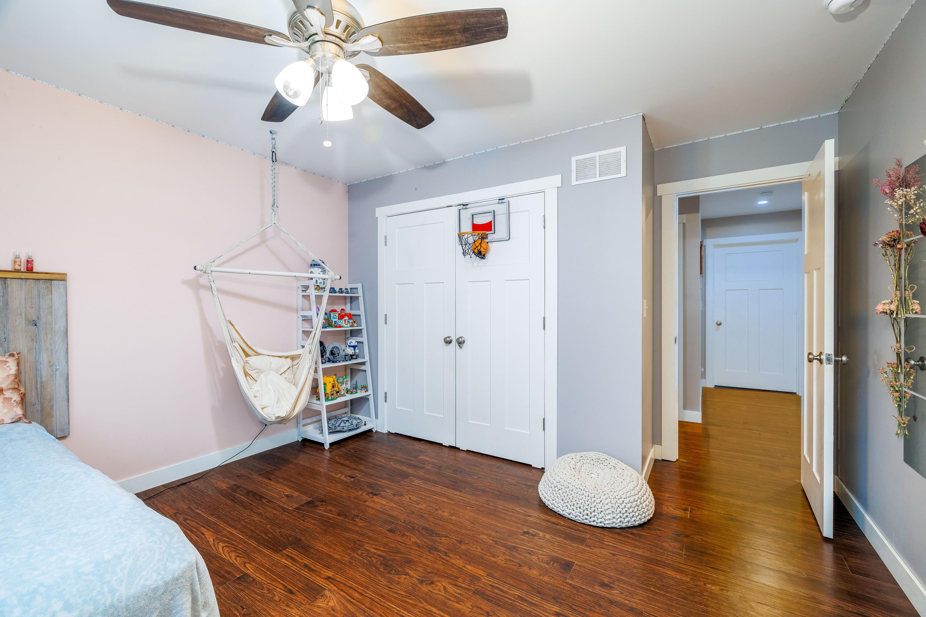 6795 Whispering Woods Drive Demotte, IN 46310 - Photo 45 of 64 a view of a livingroom with wooden floor and a ceiling fan