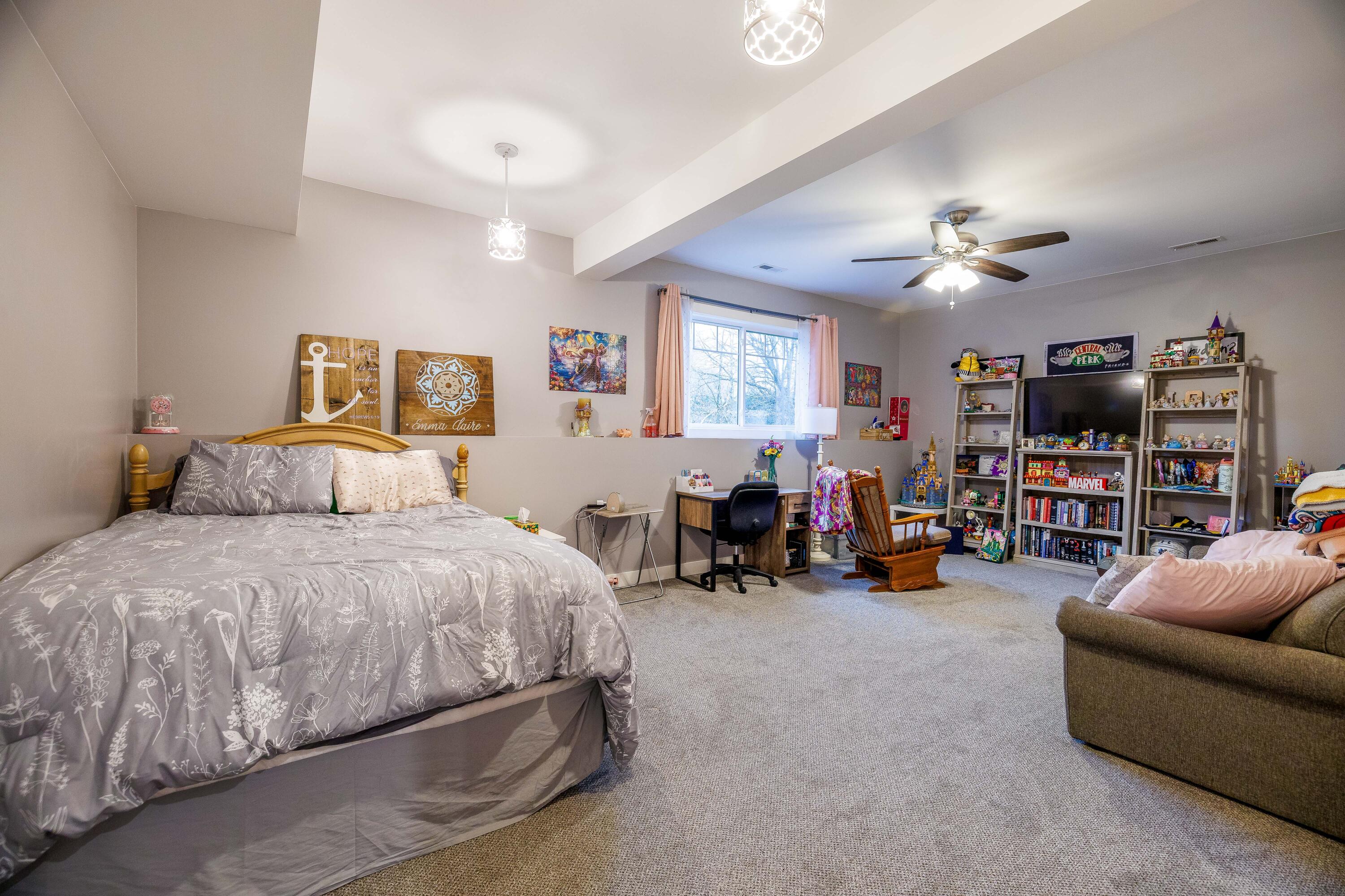 6795 Whispering Woods Drive Demotte, IN 46310 - Photo 49 of 64 a spacious bedroom with a bed a couch and a chandelier