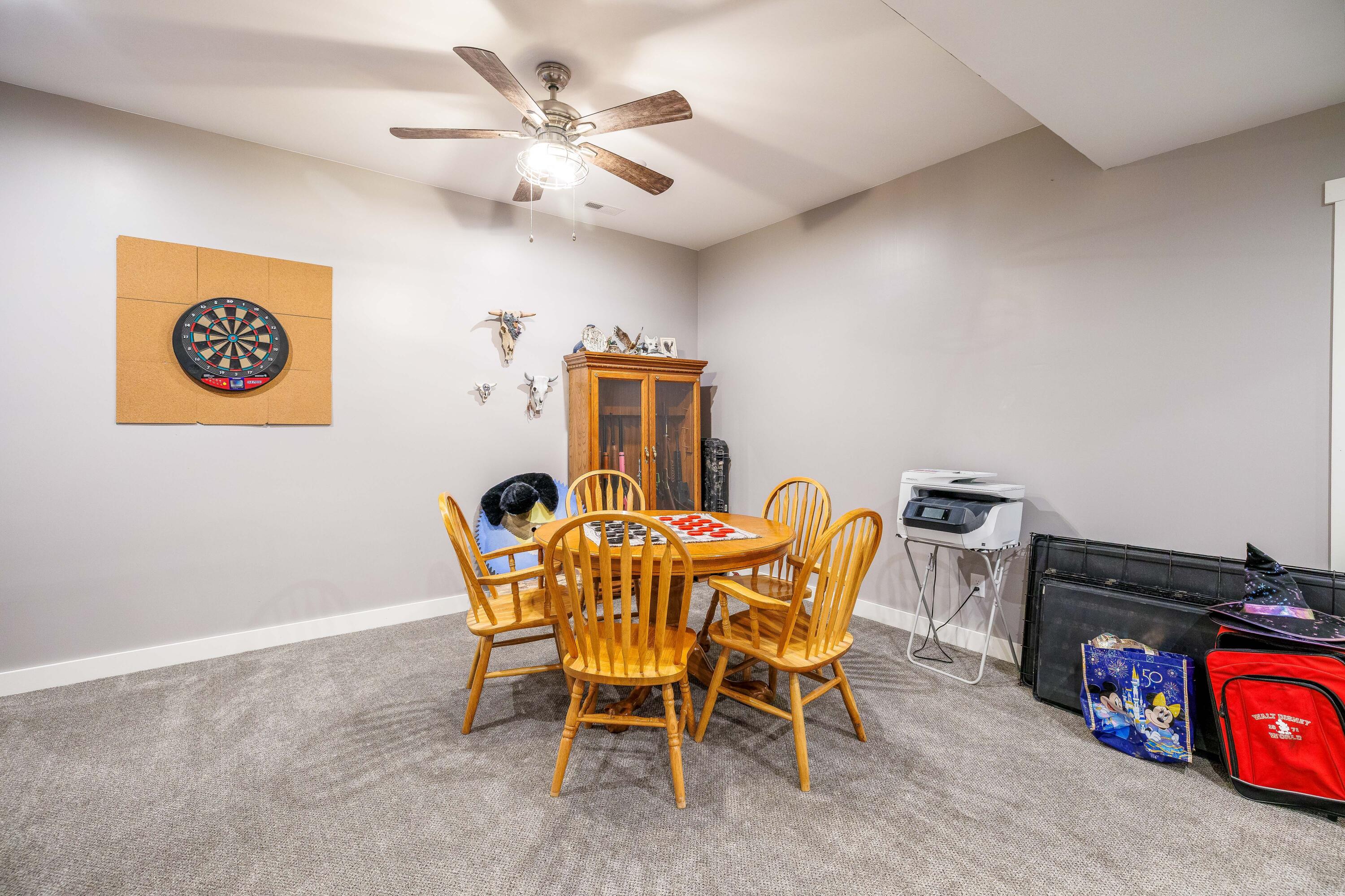 6795 Whispering Woods Drive Demotte, IN 46310 - Photo 56 of 64 a view of a dining room with furniture and a chandelier fan