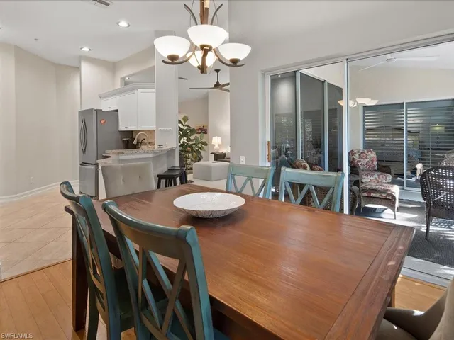 a view of a dining room with furniture a chandelier and wooden floor