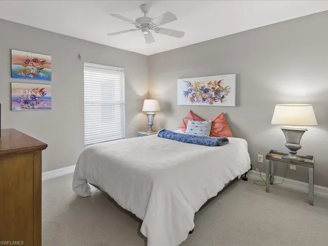 a bedroom with a bed and a lamp