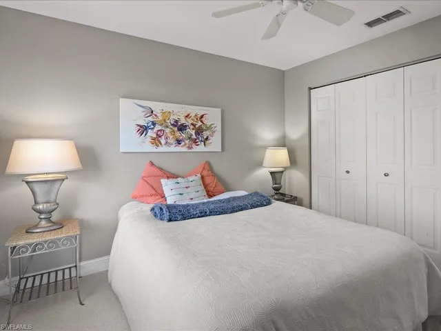 a bedroom with a bed and a lamp on table