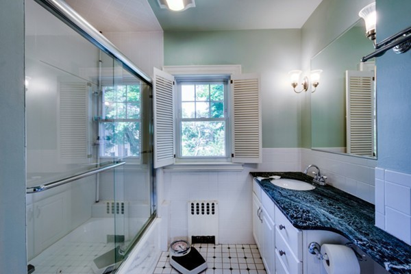 4 Bruce Road Winchester, MA 01890 - Photo 17 of 26 a bathroom with a granite countertop sink and a large mirror