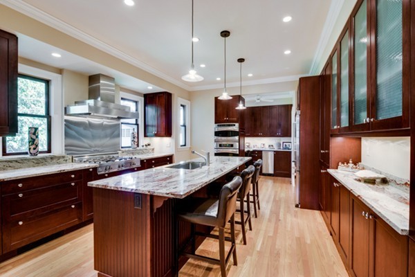 4 Bruce Road Winchester, MA 01890 - Photo 7 of 26 a kitchen with stainless steel appliances kitchen island granite countertop a stove refrigerator and cabinets