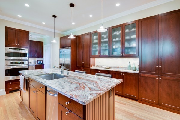 4 Bruce Road Winchester, MA 01890 - Photo 8 of 26 a kitchen with stainless steel appliances granite countertop a sink a stove and a wooden cabinets