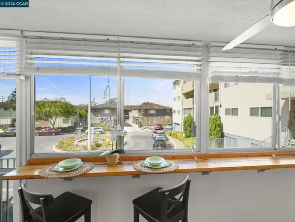 a kitchen with stainless steel appliances granite countertop a sink a stove and a wooden cabinets