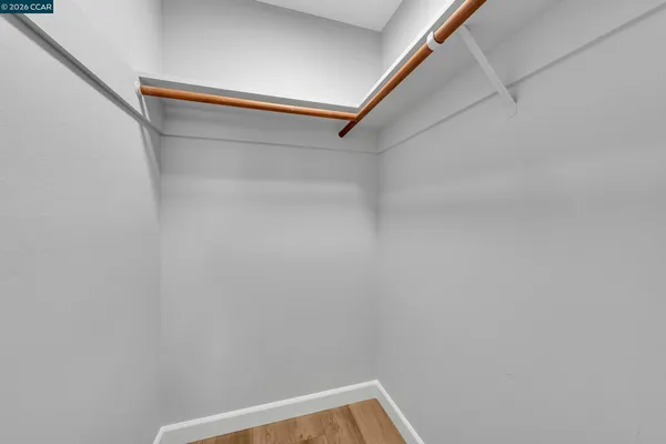 a bedroom with a bed and a lamp