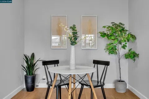 a dining room with furniture and wooden floor