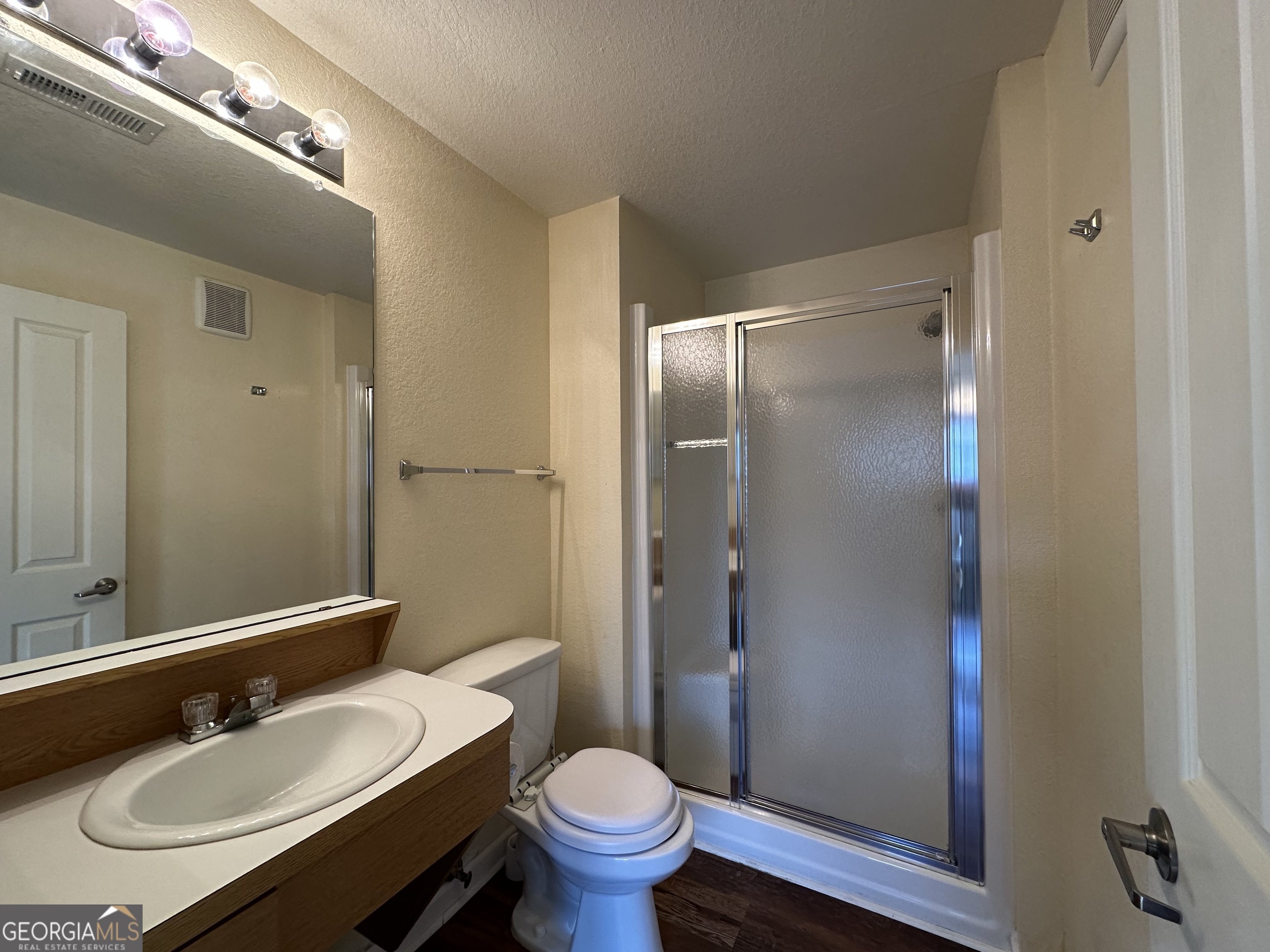 211 North Avenue Athens, GA 30601 - Photo 12 of 18 a bathroom with a granite countertop sink toilet a mirror and shower