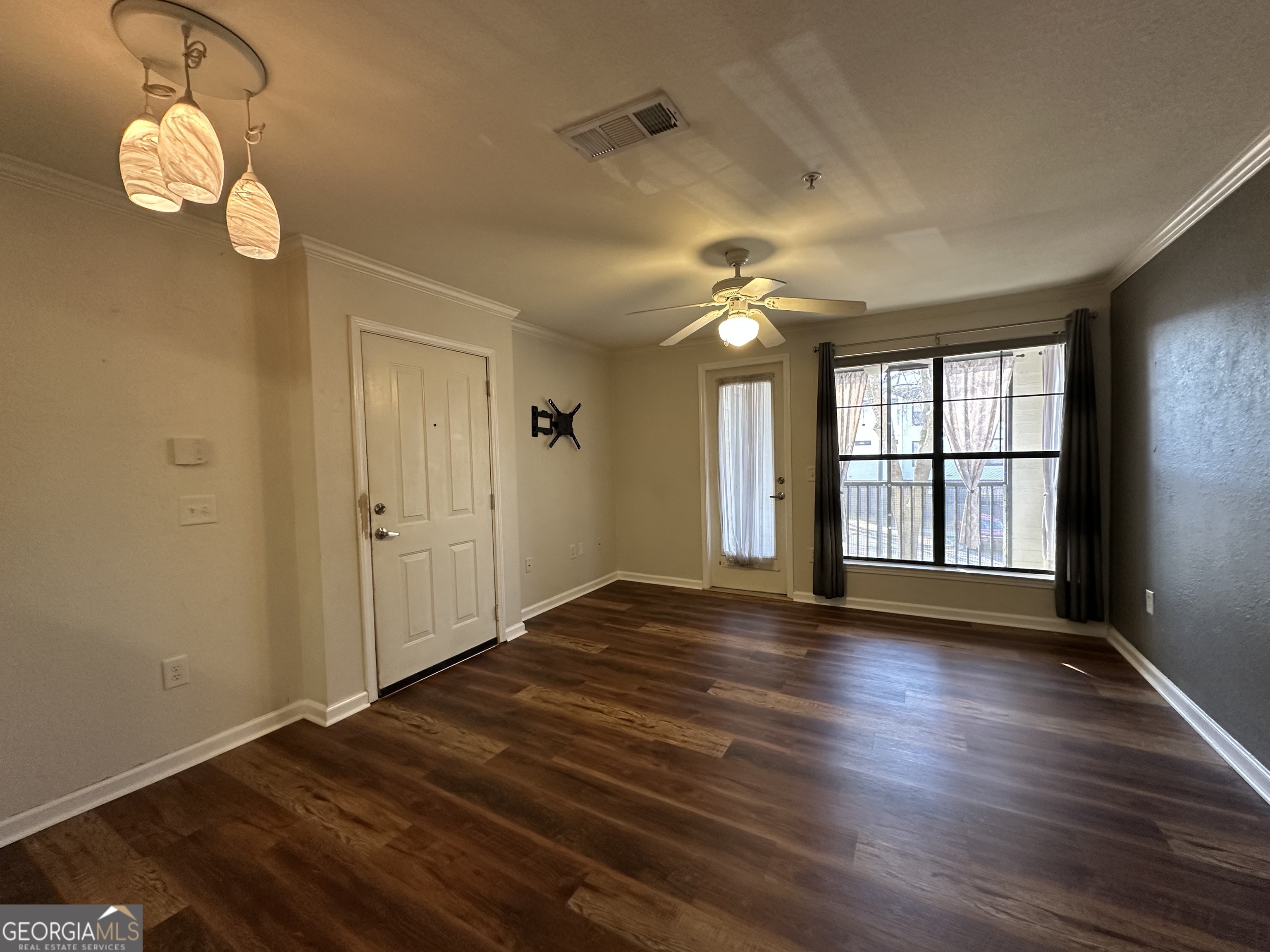 211 North Avenue Athens, GA 30601 - Photo 4 of 18 a view of an empty room with wooden floor and a window