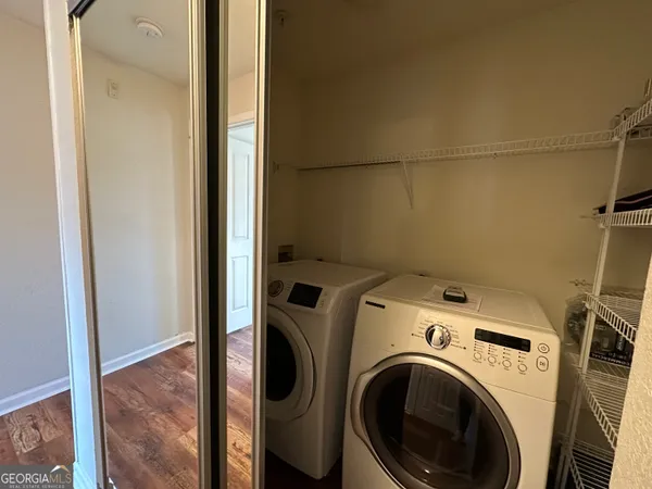 a view of storage and utility room with washer and dryer