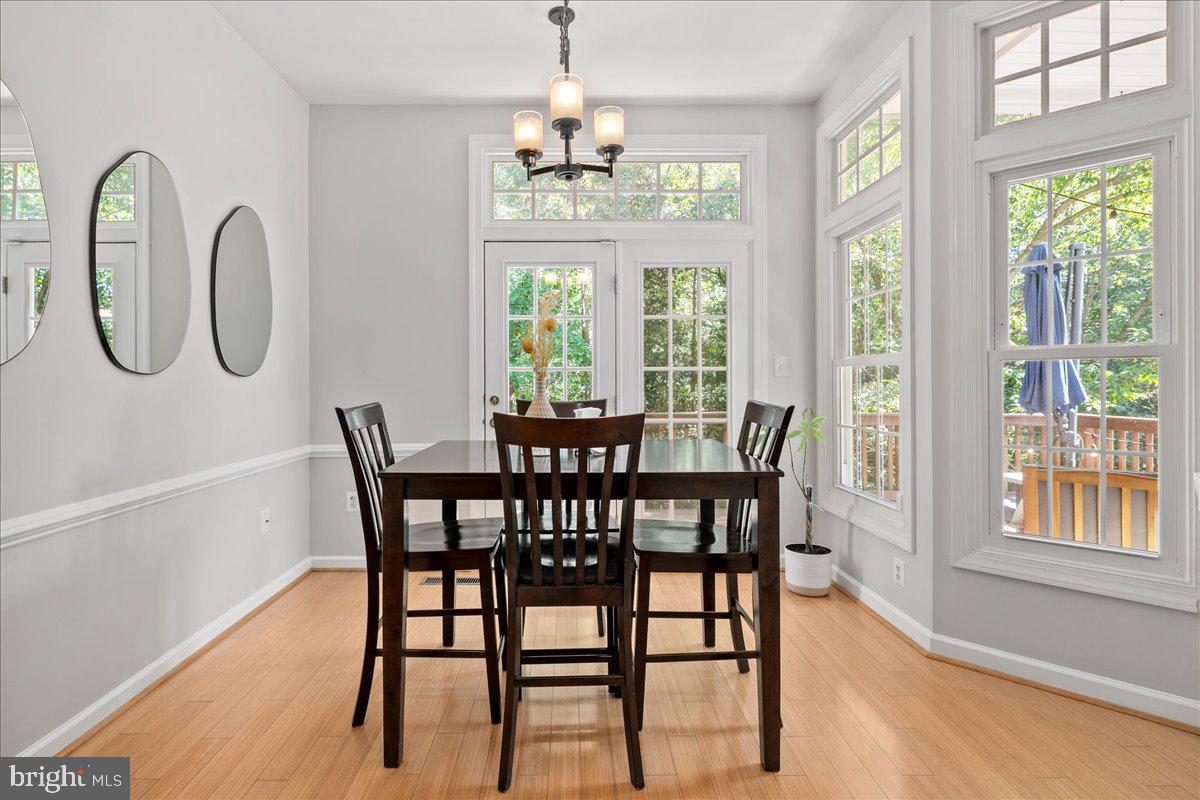 6347 Simmer Circle Springfield, VA 22150 - Photo 25 of 47 a dining room with furniture a chandelier and wooden floor