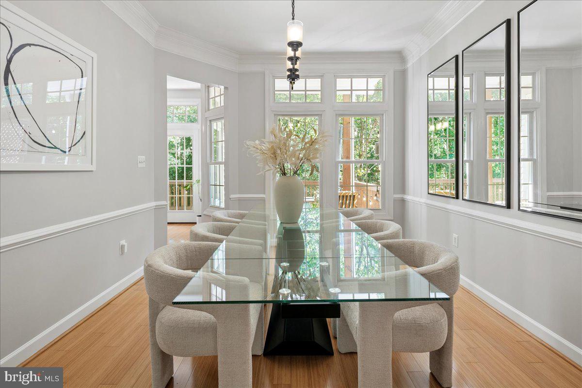 6347 Simmer Circle Springfield, VA 22150 - Photo 27 of 47 a view of a dining room with furniture a chandelier and wooden floor