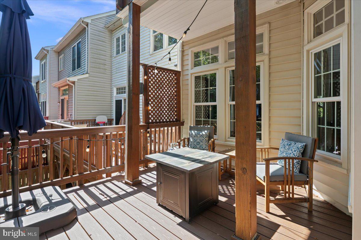 6347 Simmer Circle Springfield, VA 22150 - Photo 32 of 47 a view of a patio with table and chairs and wooden floor