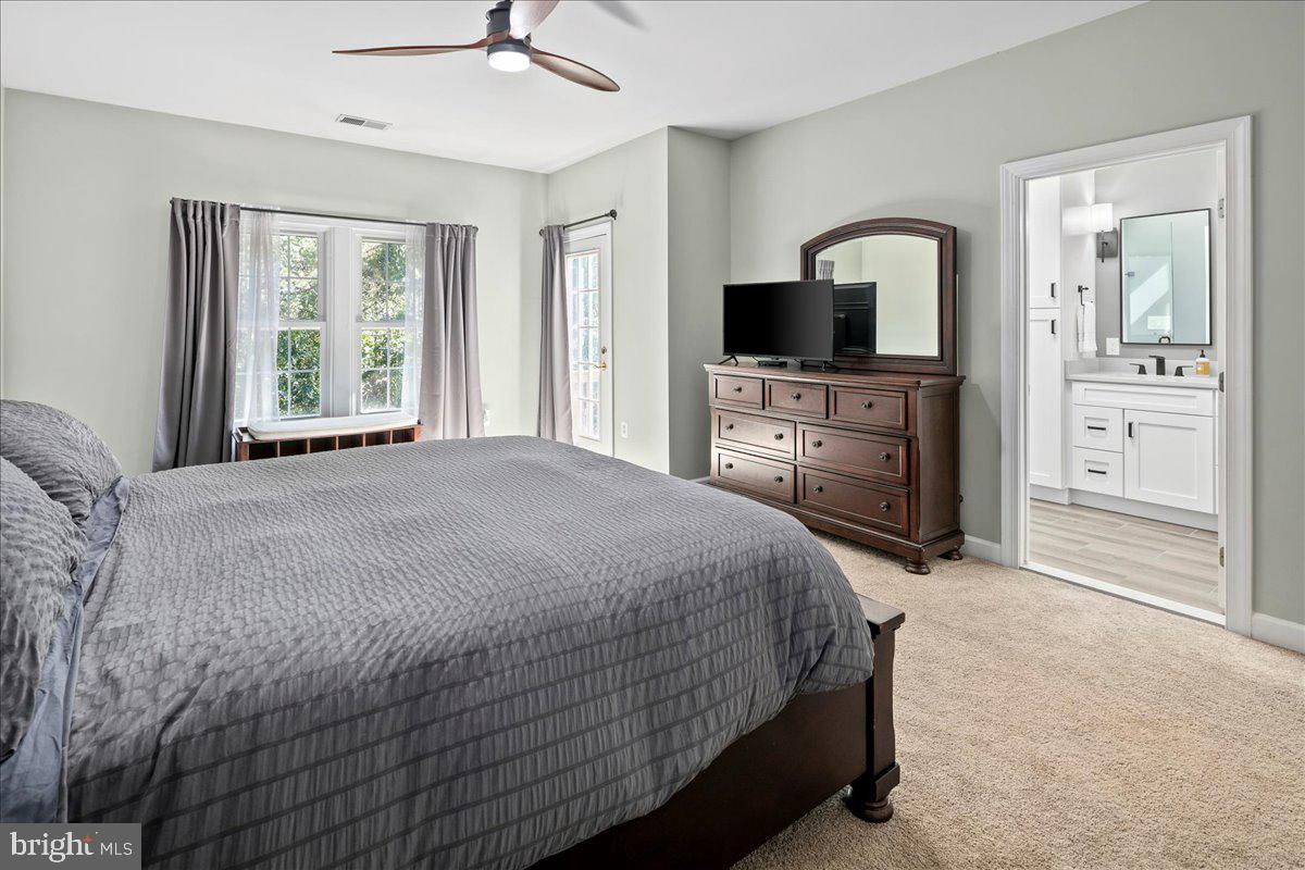 6347 Simmer Circle Springfield, VA 22150 - Photo 35 of 47 a bedroom with a bed and a flat screen tv