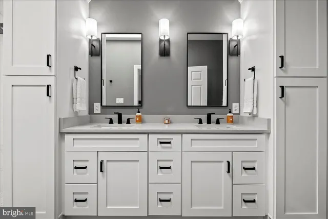 a bathroom with a double vanity sink mirror and double