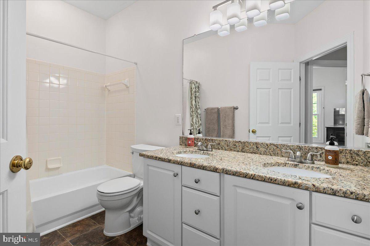 6347 Simmer Circle Springfield, VA 22150 - Photo 40 of 47 a bathroom with a granite countertop sink a toilet and bathtub