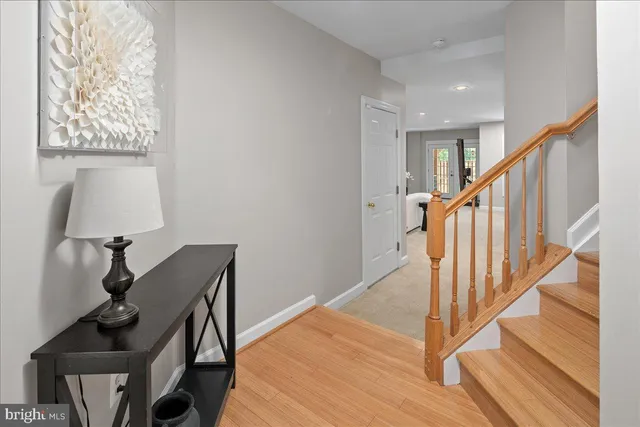 a view of entryway and hall with wooden floor