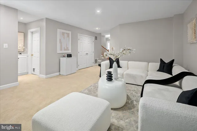 a living room with furniture and a lamp