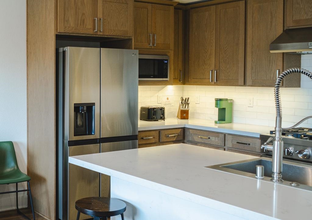 1463 Boulder Creek Road, Unit 1463 Mammoth Lakes, CA 93546 - Photo 11 of 37 a kitchen with stainless steel appliances a sink and a refrigerator